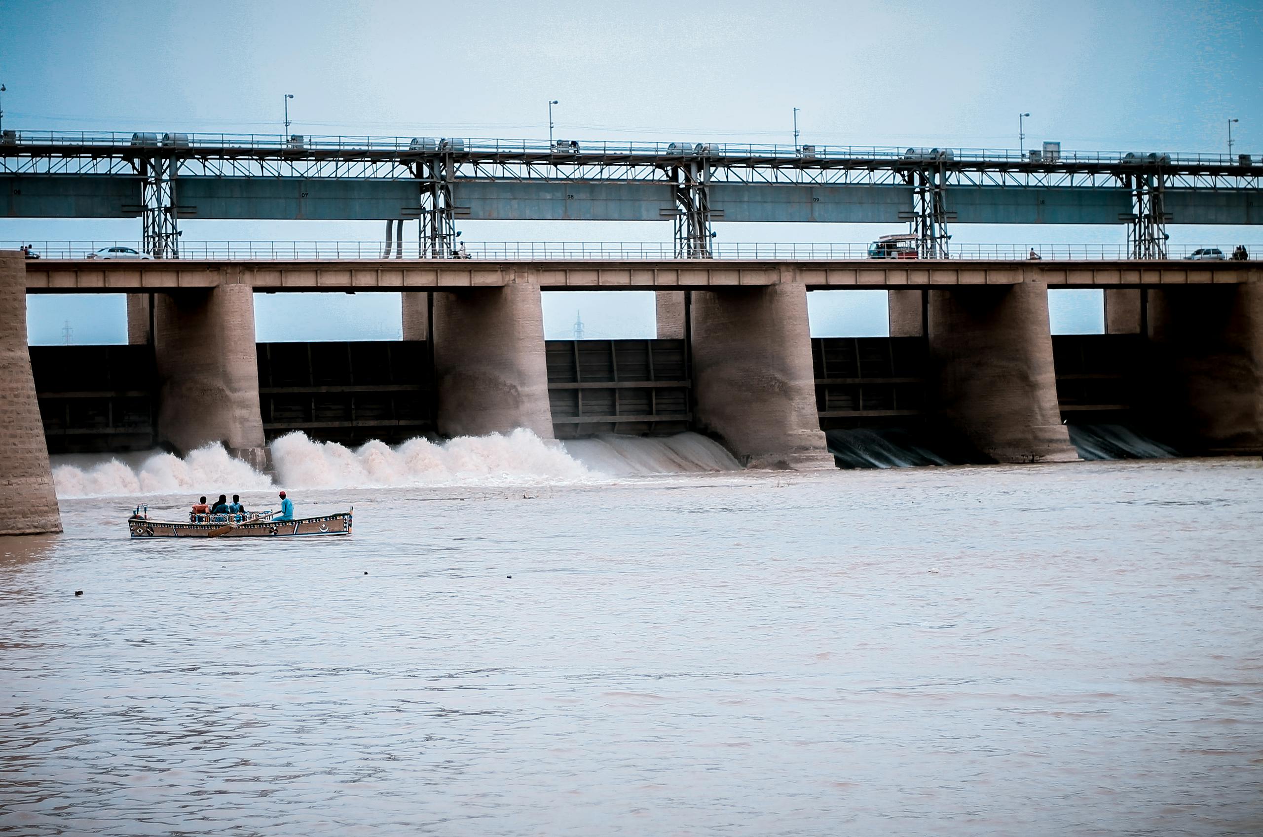 People in Boat Near Water Dam